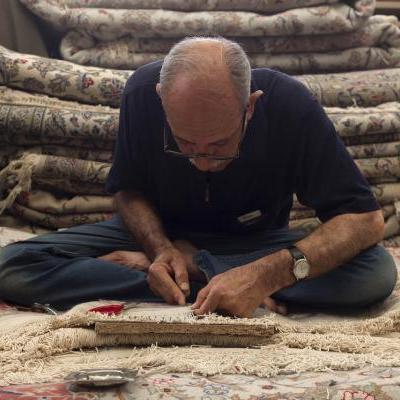 A man working on carpet repairs.