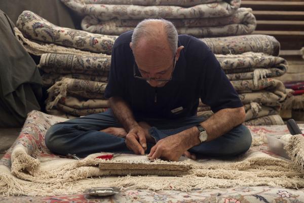 A man working on carpet repairs.